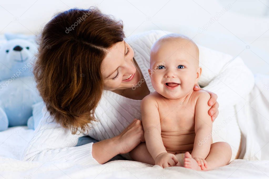 Baby and mother at home in bed. Mom and child.