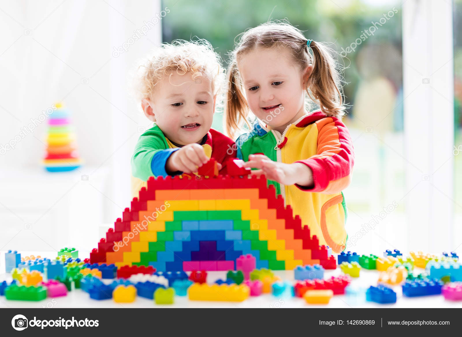 Kids playing with colorful blocks Stock Photo by ©FamVeldman 142690869