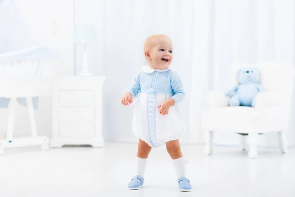 First steps of baby boy learning to walk