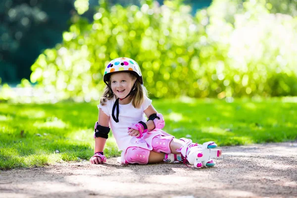 Little girl with roller skate shoes in a park