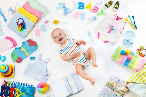 Дитина з одягом та предметами догляду за немовлям — стокове фото