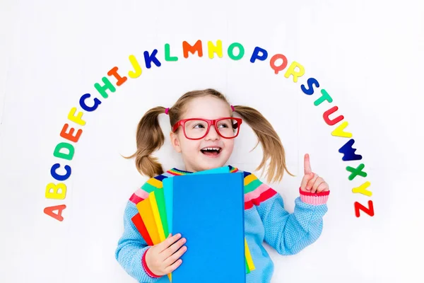 Child learning letters of alphabet and reading — Stock Photo, Image