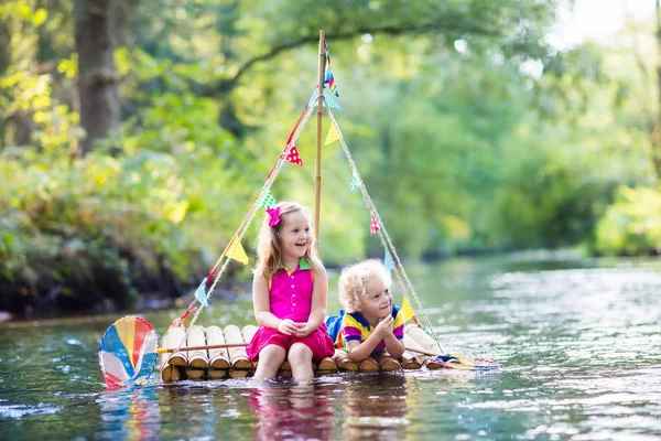 Kids on wooden raft — Stock Photo, Image