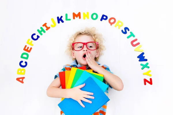 Child learning letters of alphabet and reading — Stock Photo, Image