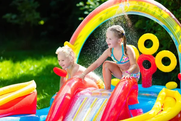 Kids playing in inflatable swimming pool — Stock Photo, Image