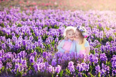 Sümbül çiçek çiçek açan bahçesinde oynayan çocuklar