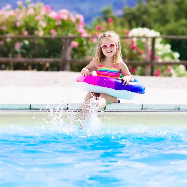 Child with toy ring in swimming pool — Stock Photo, Image