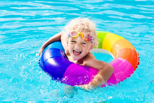 Child with toy ring in swimming pool — Stock Photo, Image