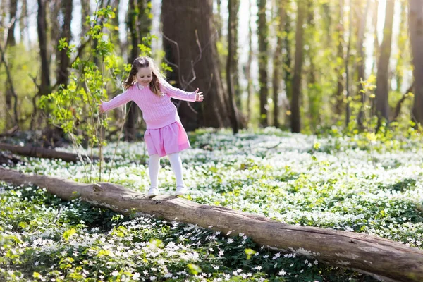 Child in spring park with flowers — Stock Photo, Image