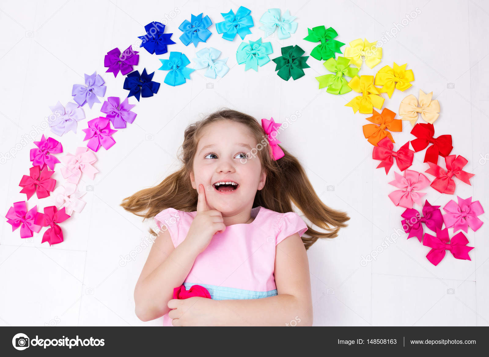 Little girl with colorful bow. Hair accessory Stock Photo by ©FamVeldman  148508163