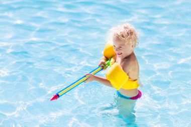 Child playing in swimming pool clipart
