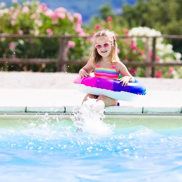 Child with toy ring in swimming pool — Stock Photo, Image