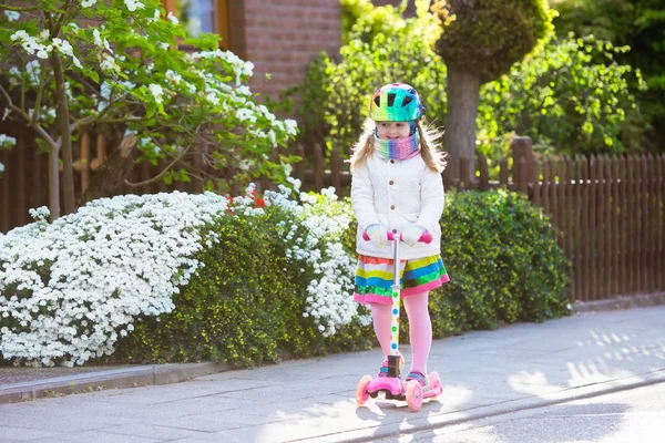 Child riding schooter on way to school — Stock Photo, Image