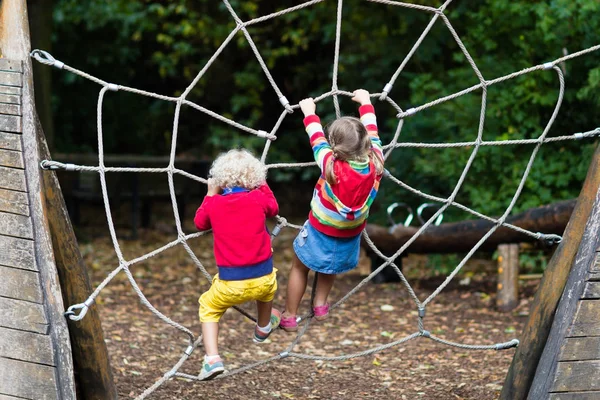 Children climb on school yard playground — Stock Photo, Image