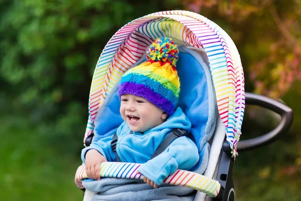 Baby boy in stroller in autumn park — Stock Photo, Image