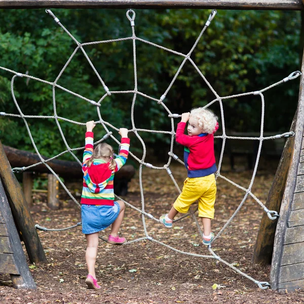 Children climb on school yard playground — Stock Photo, Image