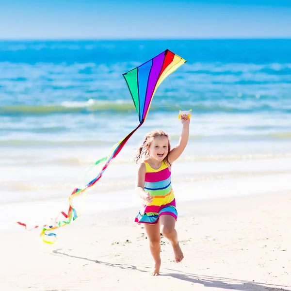 Child flying kite on tropical beach