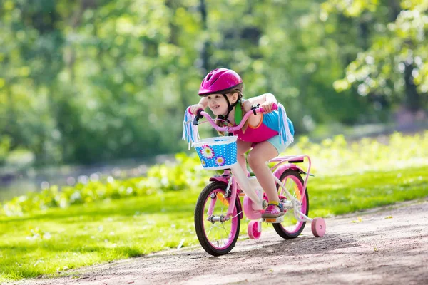 Child riding bike. Kid on bicycle.