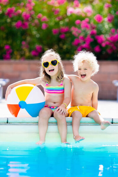 Kids playing at outdoor swimming pool
