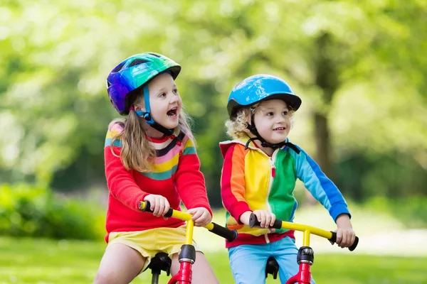 Kids ride balance bike in park — Stock Photo, Image