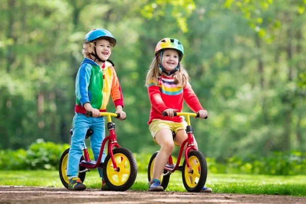 Crianças passeio de bicicleta de equilíbrio no parque — Fotografia de Stock