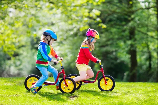 Kids ride balance bike in park — Stock Photo, Image