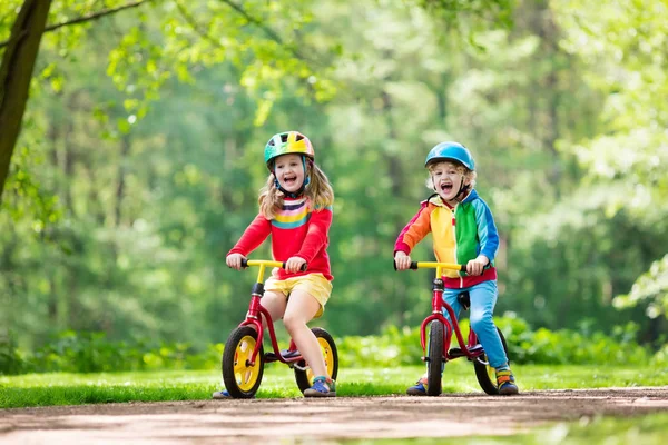 Kids ride balance bike in park — Stock Photo, Image