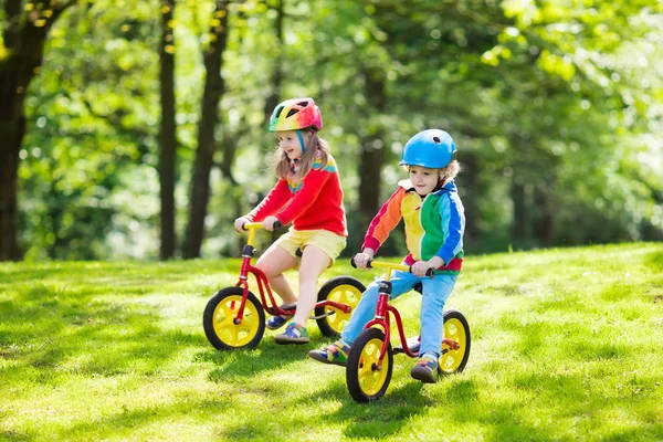 Kids ride balance bike in park — Stock Photo, Image