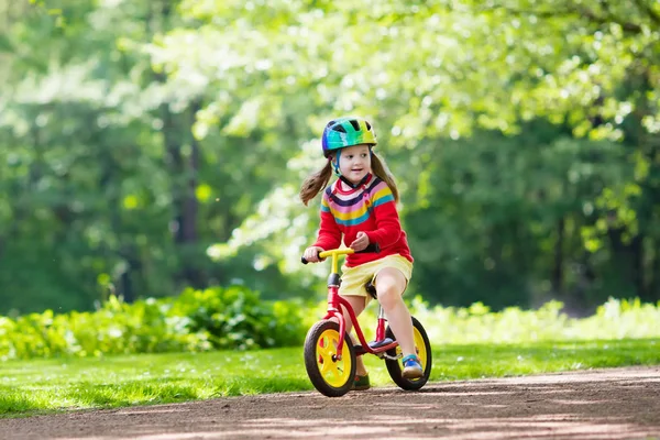 Kids ride balance bike in park — Stock Photo, Image