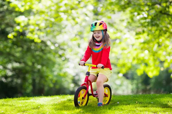 Kids ride balance bike in park Royalty Free Stock Images