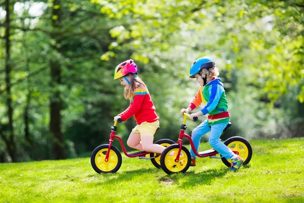 Kids ride balance bike in park — Stock Photo, Image