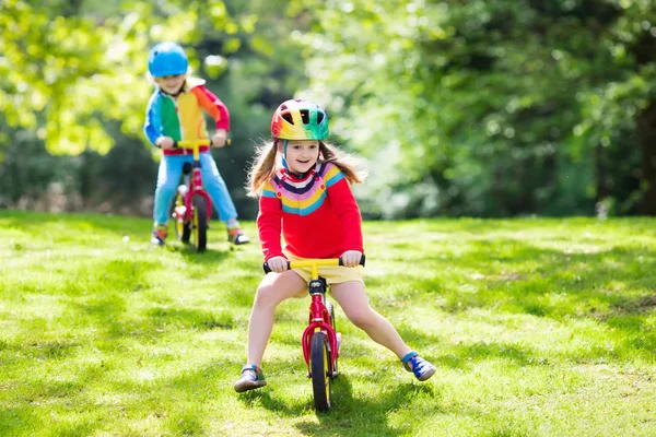 Kids ride balance bike in park — Stock Photo, Image