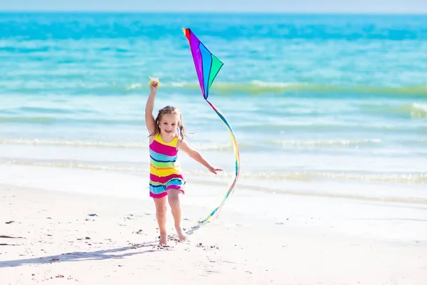 De vliegende kite kind op tropisch strand — Stockfoto