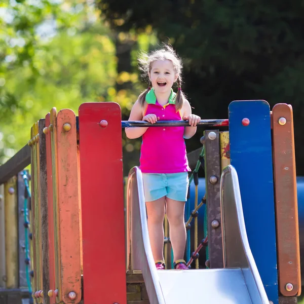 Kind spelen op de speelplaats in de zomer — Stockfoto