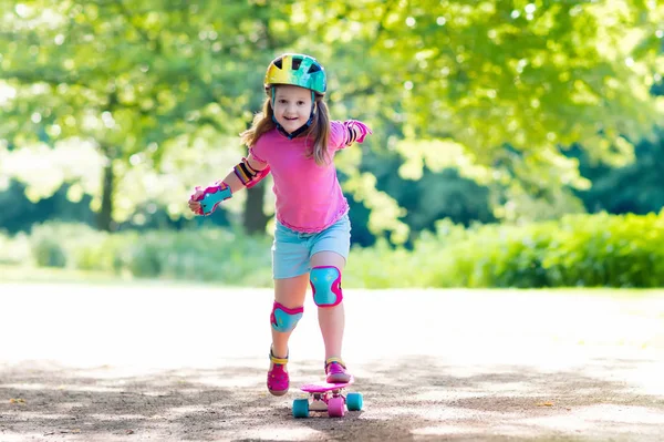 Børne ridning skateboard i sommerpark - Stock-foto