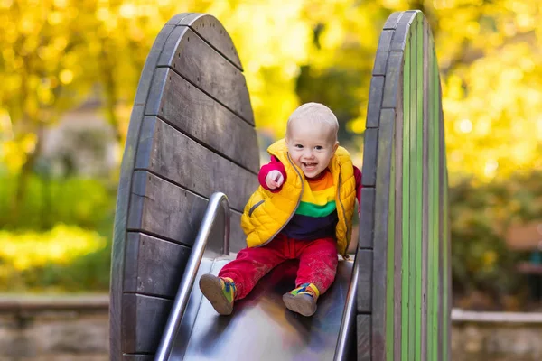 Criança no playground no outono. Crianças em queda. — Fotografia de Stock