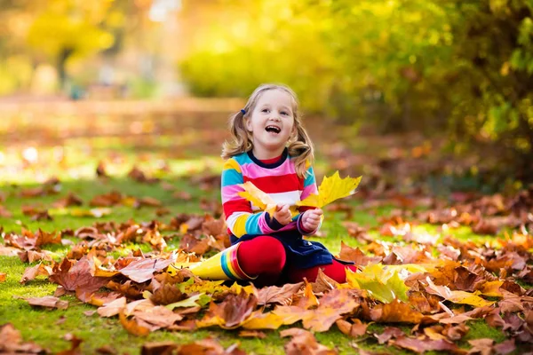 Bambino nel parco autunnale. Ragazzo con foglie autunnali . — Foto Stock