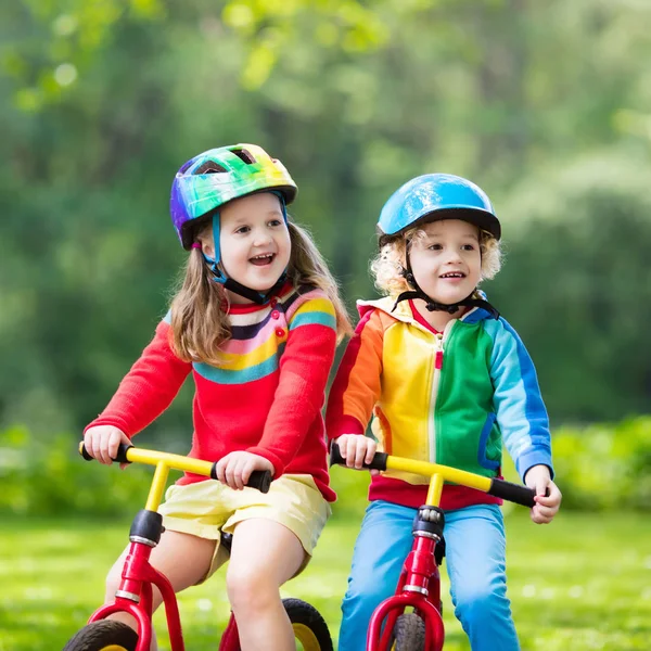 Kids ride balance bike in park — Stock Photo, Image