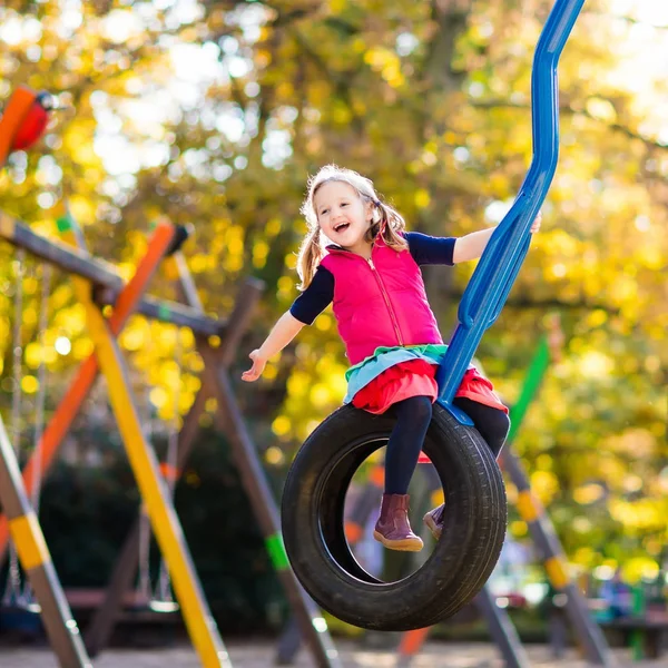 Child on playground in autumn. Kids in fall. — Stock Photo, Image