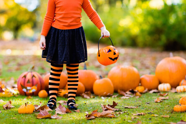 Little girl in witch costume on Halloween trick or treat