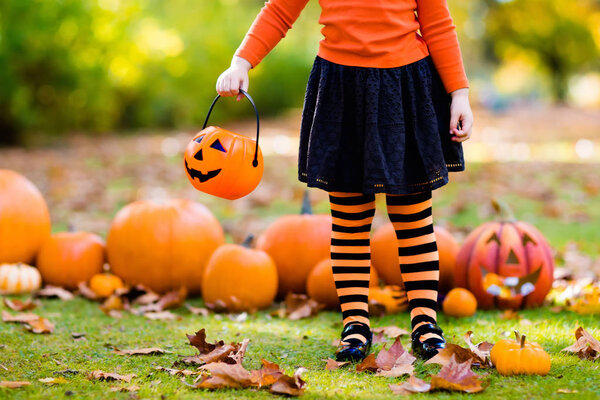 Little girl in witch costume on Halloween trick or treat