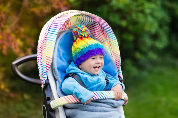 Baby boy in stroller in autumn park — Stock Photo, Image