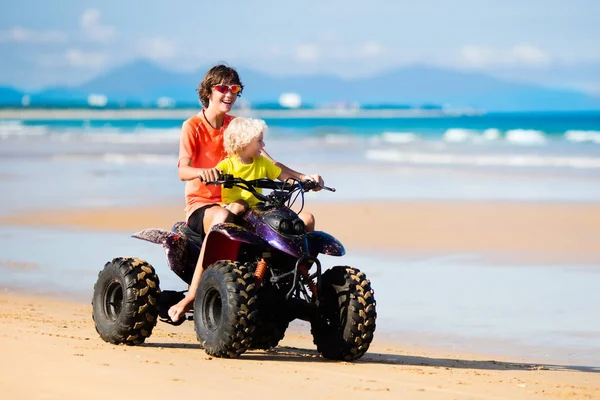 Kids on quad bike. Off road all terrain vehicle. — Stock Photo, Image