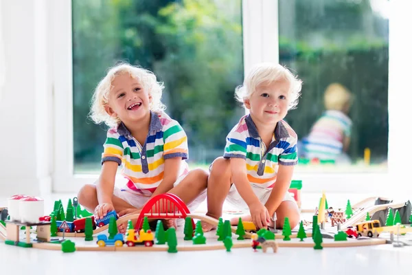 Children play wiht toy train. Kids wooden railway. — Stock Photo, Image