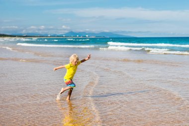 Çocuk tropik sahilde. Deniz tatil çocuklarla.