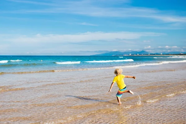 Çocuk tropik sahilde. Deniz tatil çocuklarla.