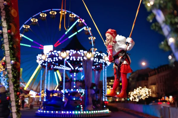 Child at Christmas fair. Kids bungee jumping. — Stock Photo, Image