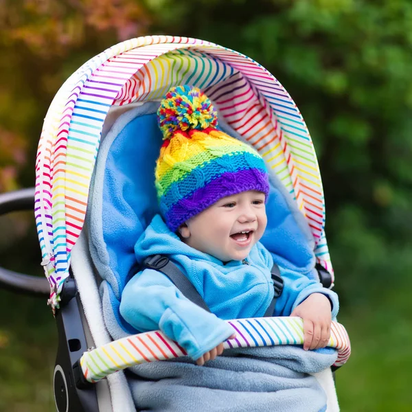 Baby boy in stroller in autumn park — Stock Photo, Image