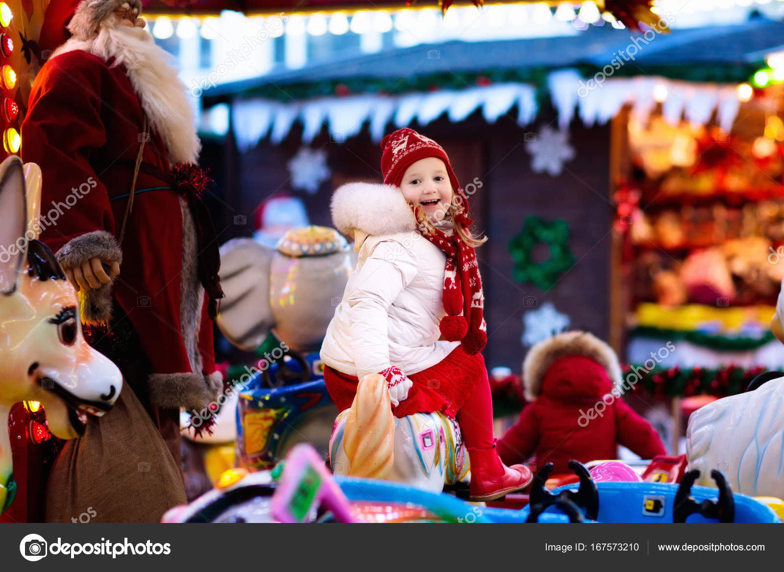 Child On Christmas Fair Kid Riding Xmas Carousel Stock Photo