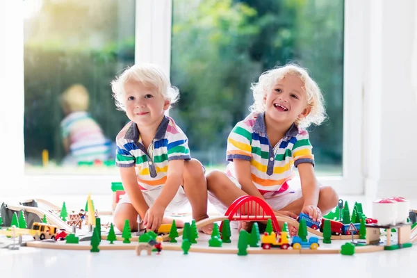 Children play wiht toy train. Kids wooden railway. — Stock Photo, Image